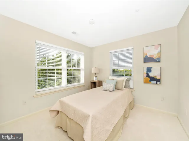 a bedroom with a large bed and a large window