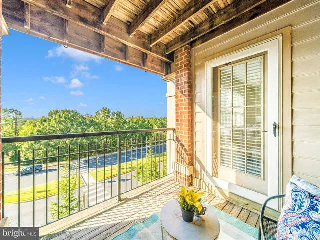 a view of a big house with a big yard and large trees