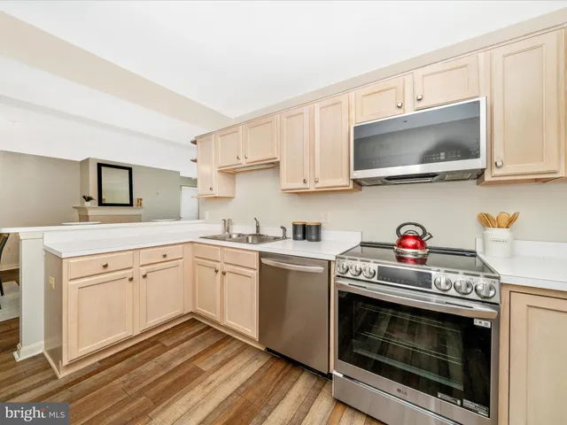 a kitchen with stainless steel appliances granite countertop a stove and a microwave