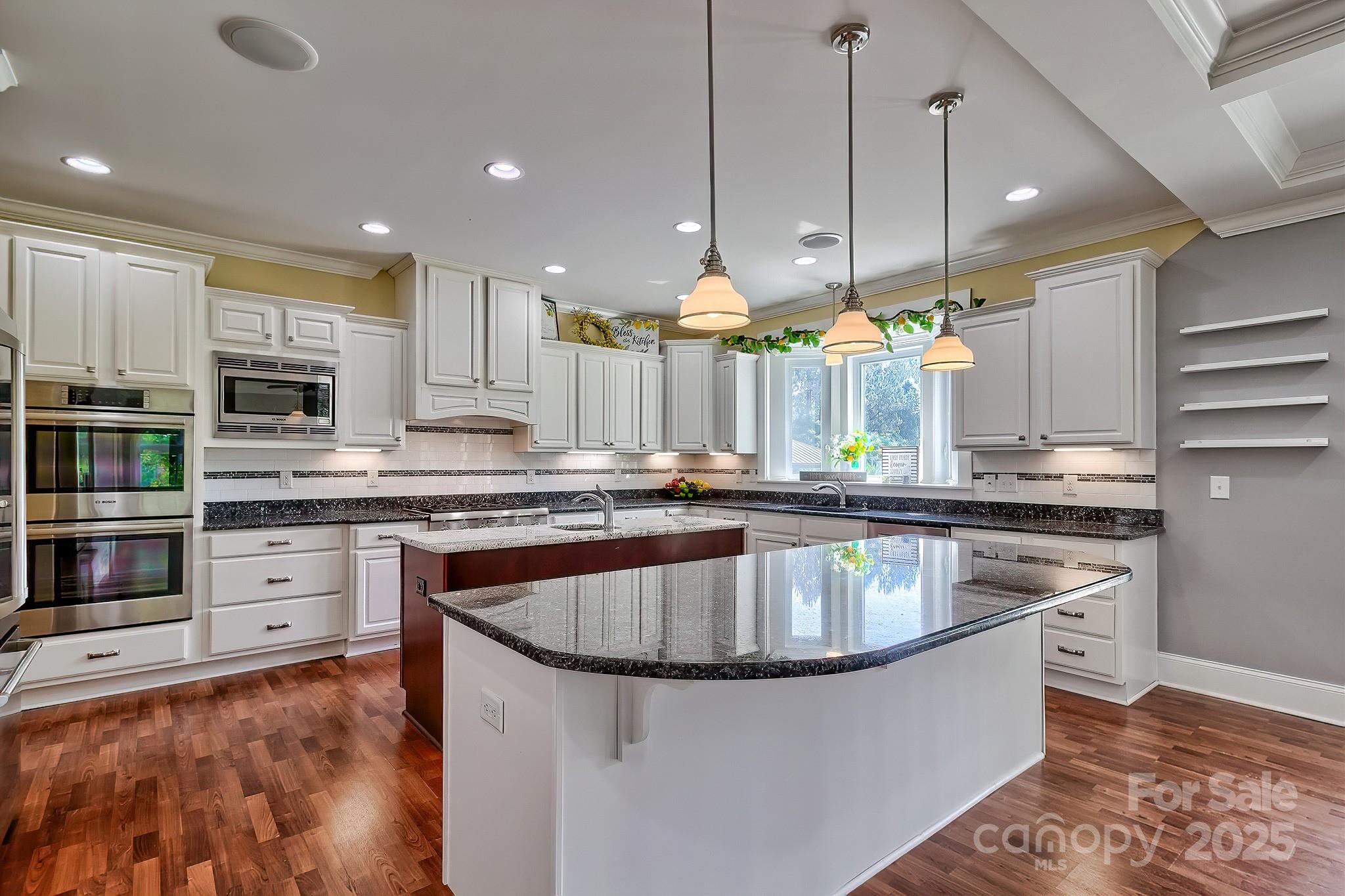 6268 Hope Road Winnsboro, SC 29180 - Photo 22 of 48 a kitchen with kitchen island granite countertop a stove and a sink