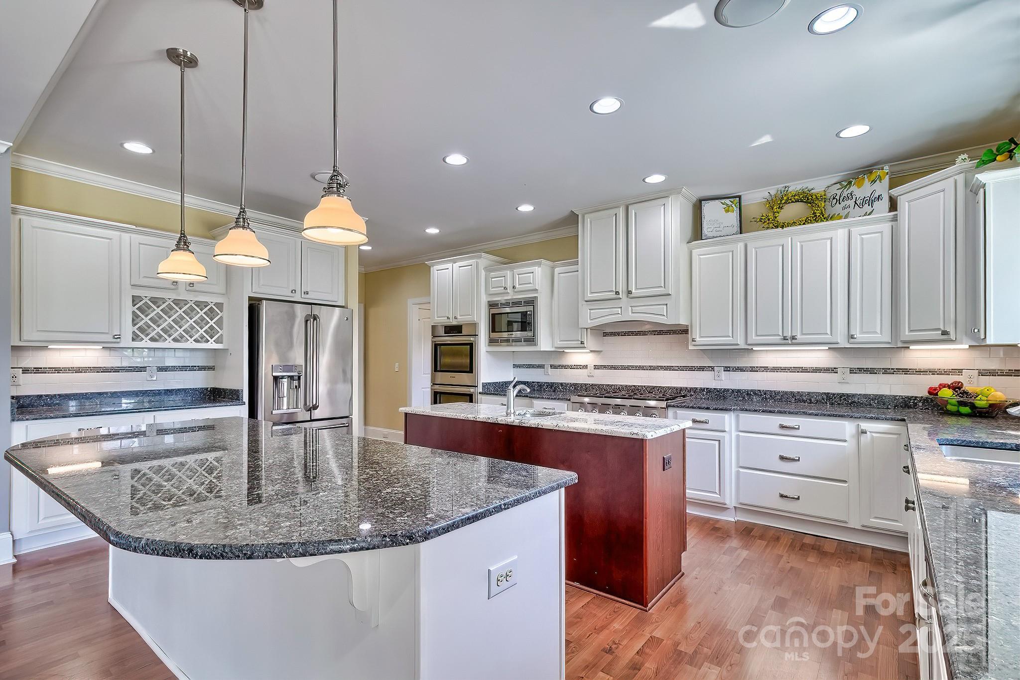 6268 Hope Road Winnsboro, SC 29180 - Photo 23 of 48 a kitchen with kitchen island granite countertop a stove a sink a oven and a dining table