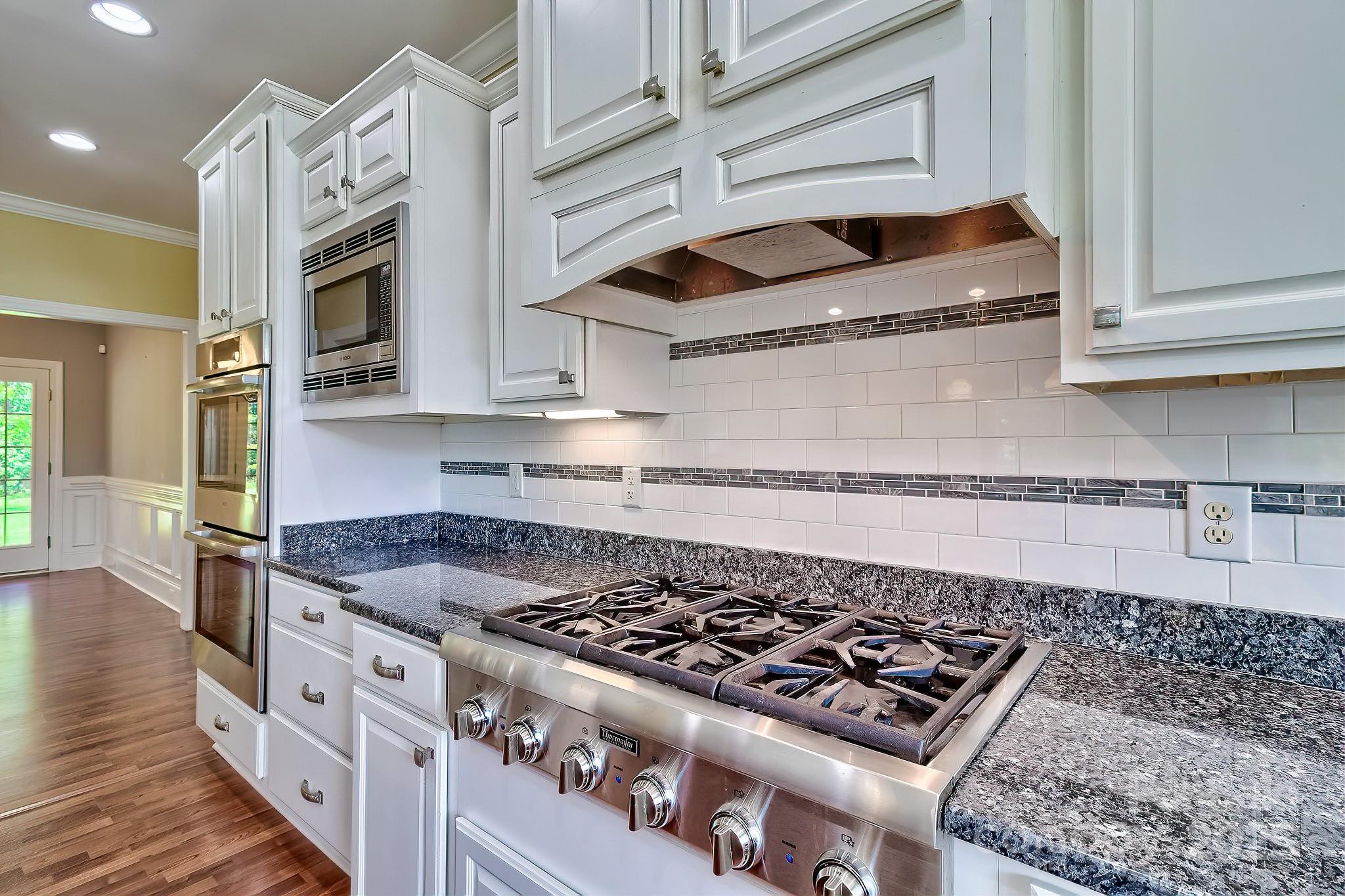 6268 Hope Road Winnsboro, SC 29180 - Photo 25 of 48 a kitchen with stainless steel appliances granite countertop a stove and a microwave