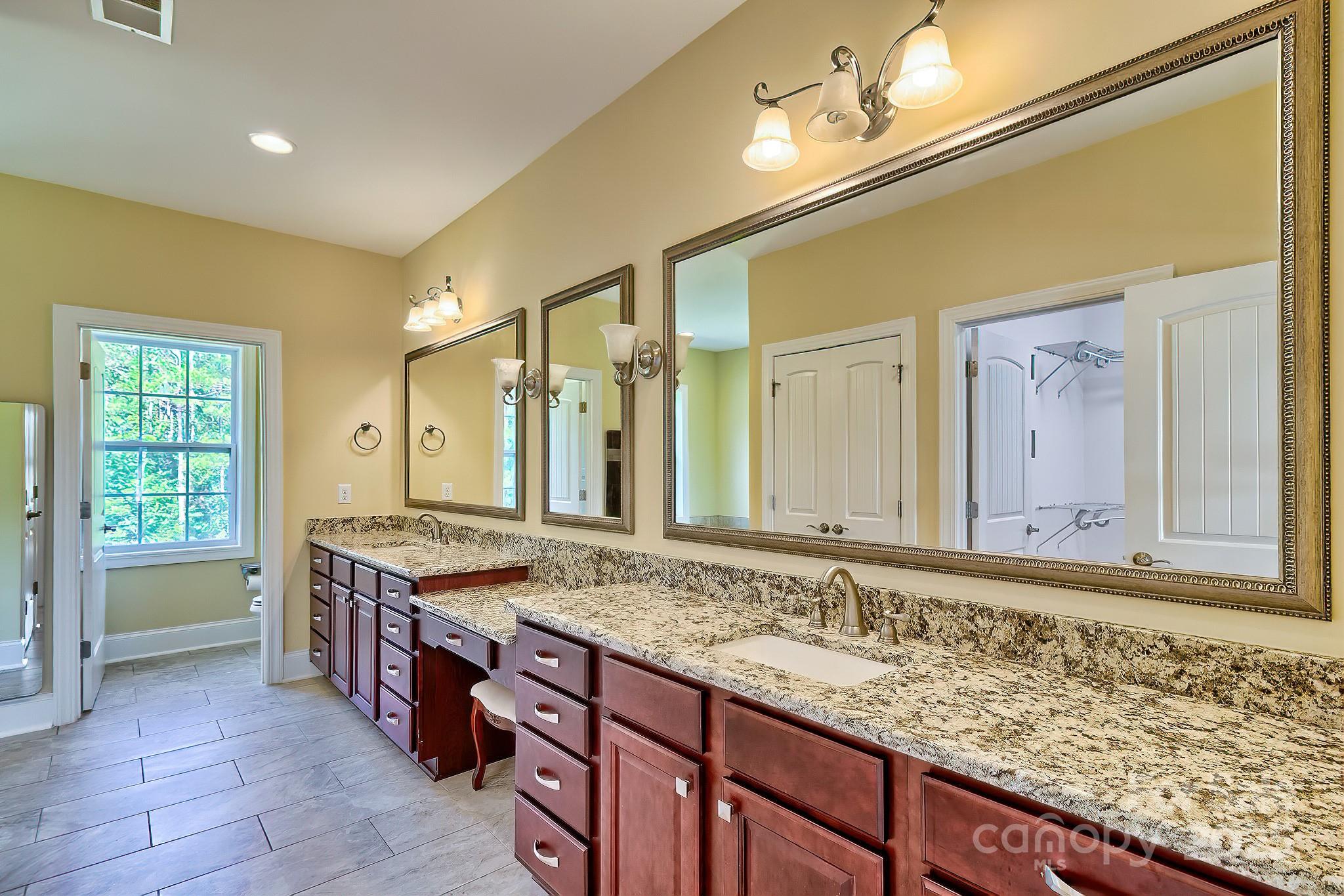 6268 Hope Road Winnsboro, SC 29180 - Photo 35 of 48 a bathroom with a granite countertop sink and a large mirror