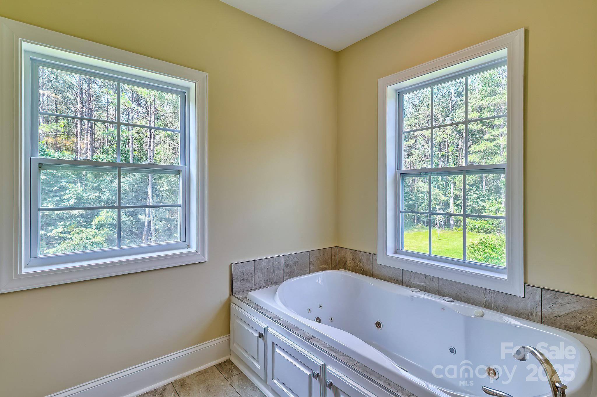 6268 Hope Road Winnsboro, SC 29180 - Photo 37 of 48 a bathroom with a bathtub and a window