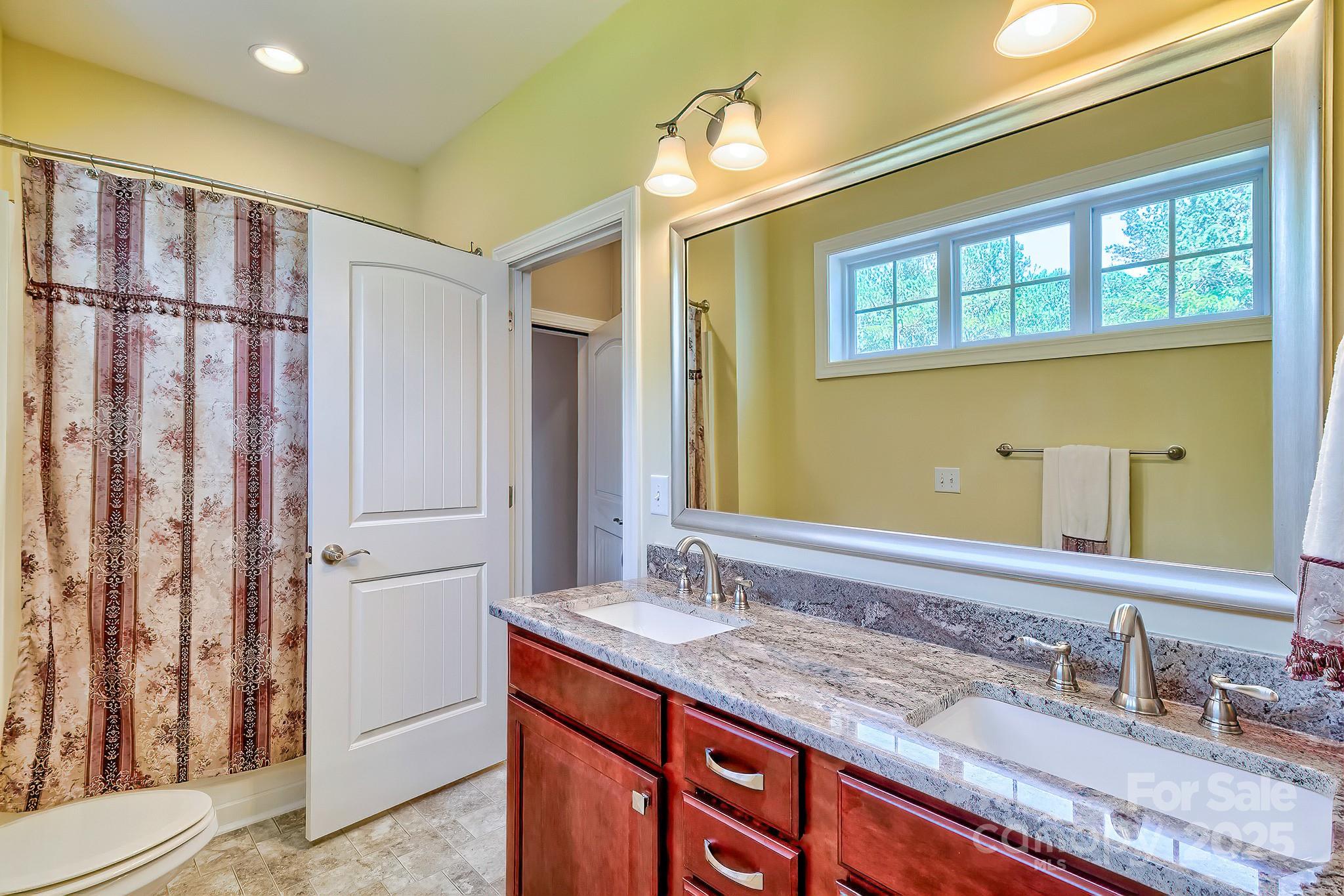 6268 Hope Road Winnsboro, SC 29180 - Photo 42 of 48 a bathroom with a granite countertop sink mirror and double