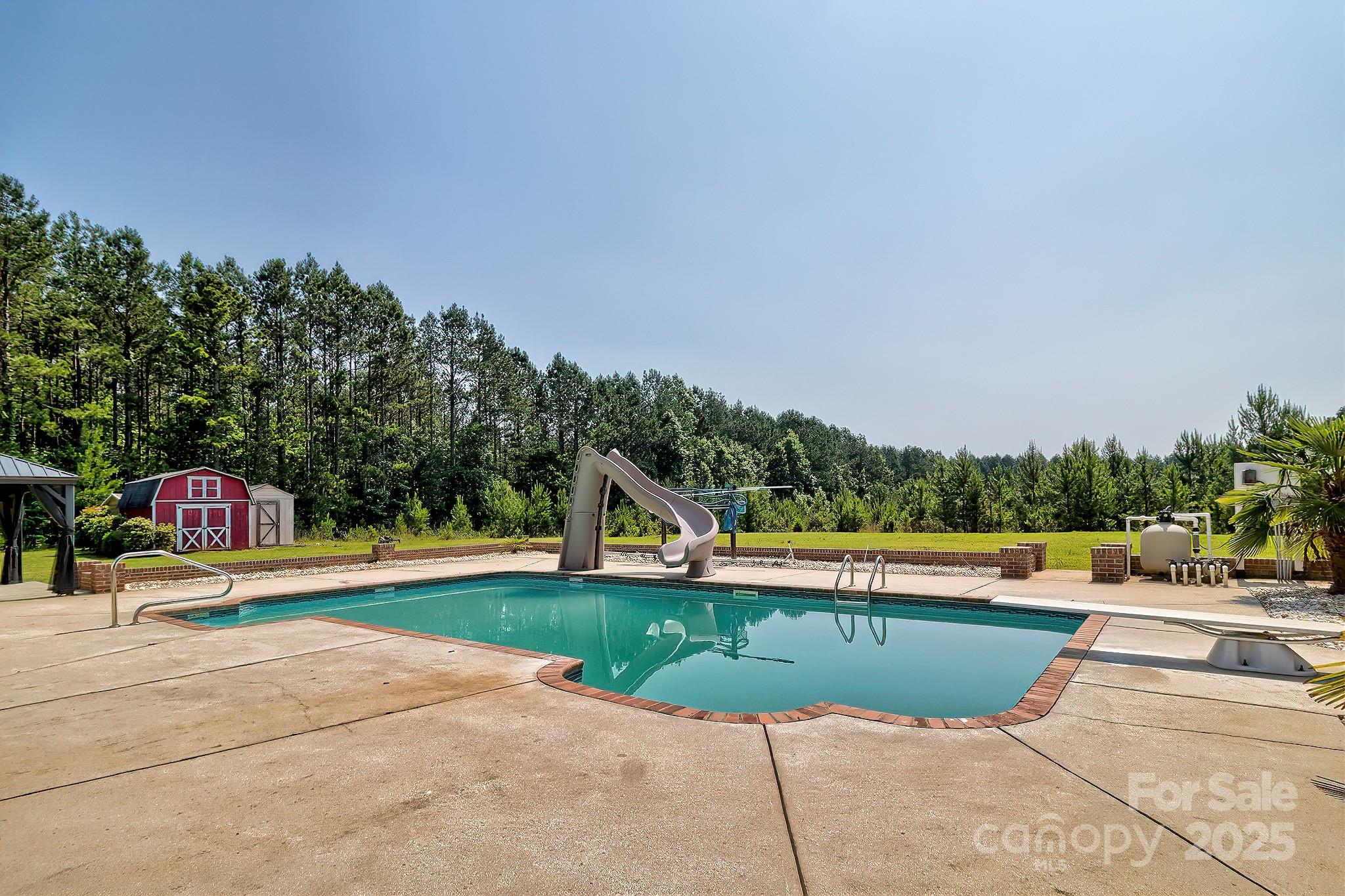 6268 Hope Road Winnsboro, SC 29180 - Photo 9 of 48 a view of swimming pool with an outdoor seating and a garden