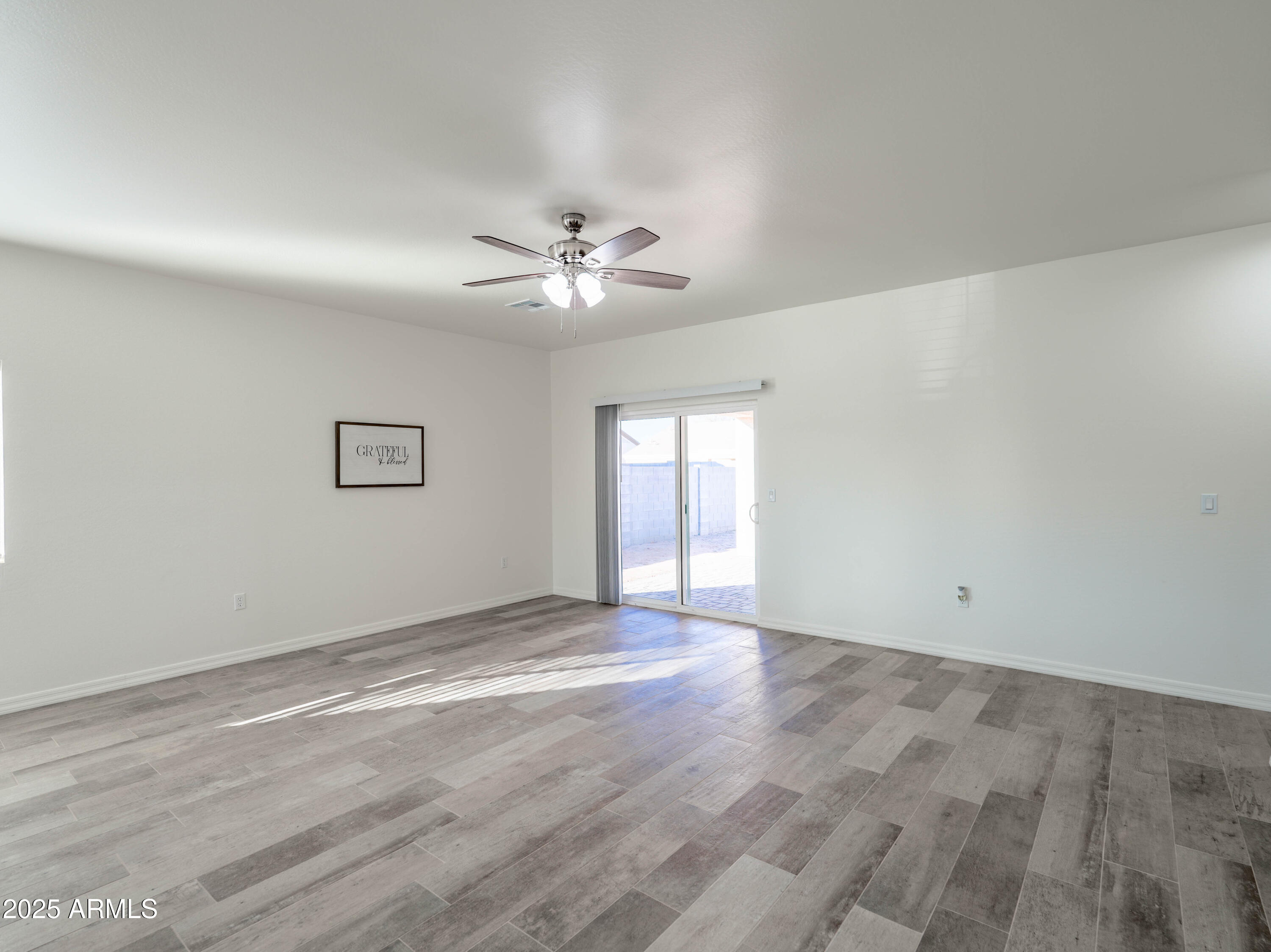 14534 South Diablo Road Arizona City, AZ 85123 - Photo 10 of 36 wooden floor in an empty room with a window