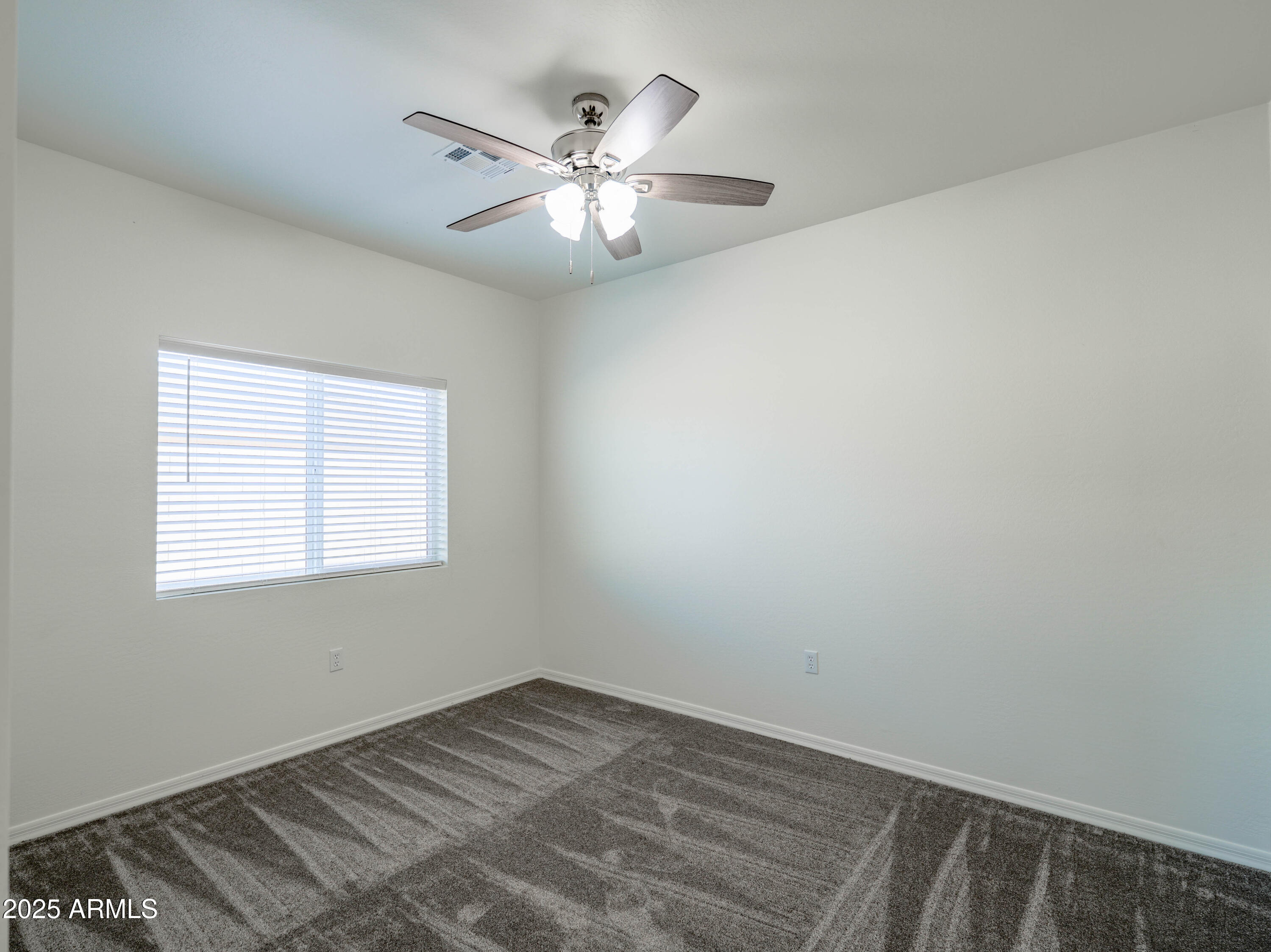 14534 South Diablo Road Arizona City, AZ 85123 - Photo 19 of 36 an empty room with wooden floor and windows