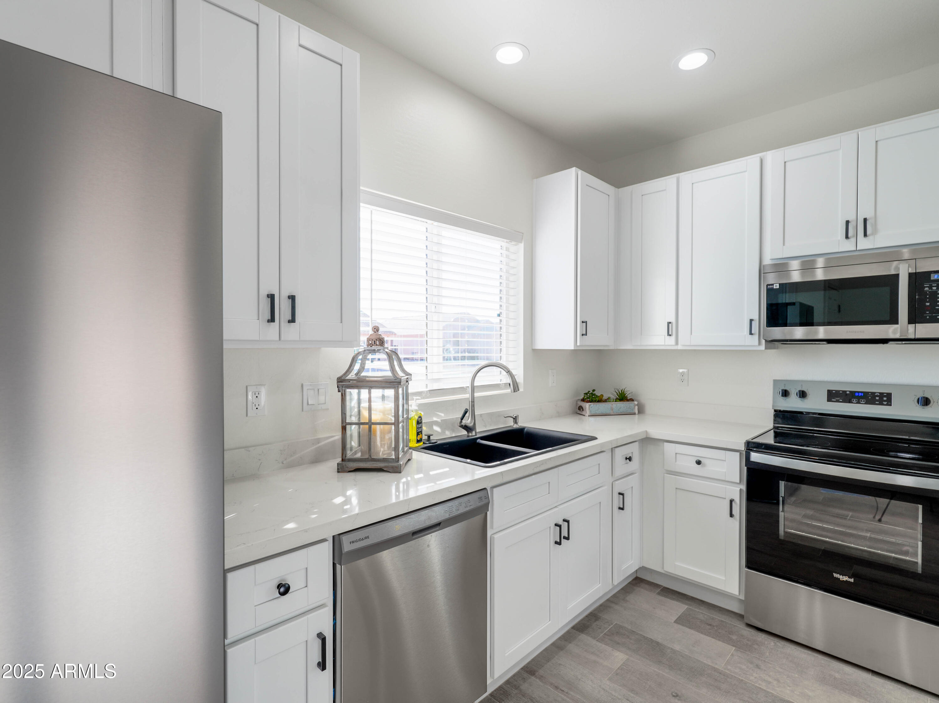 14534 South Diablo Road Arizona City, AZ 85123 - Photo 6 of 36 a kitchen with granite countertop white cabinets and stainless steel appliances