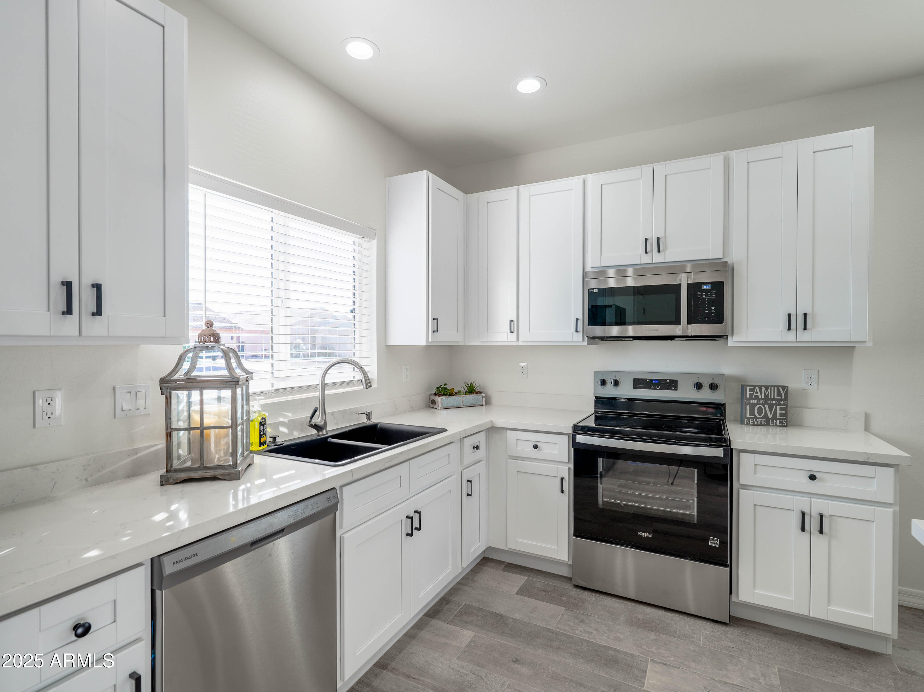 14534 South Diablo Road Arizona City, AZ 85123 - Photo 7 of 36 a kitchen with white cabinets appliances a sink and a window