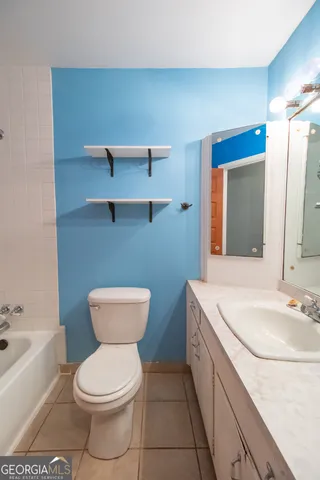 a bathroom with a toilet a sink and bathtub