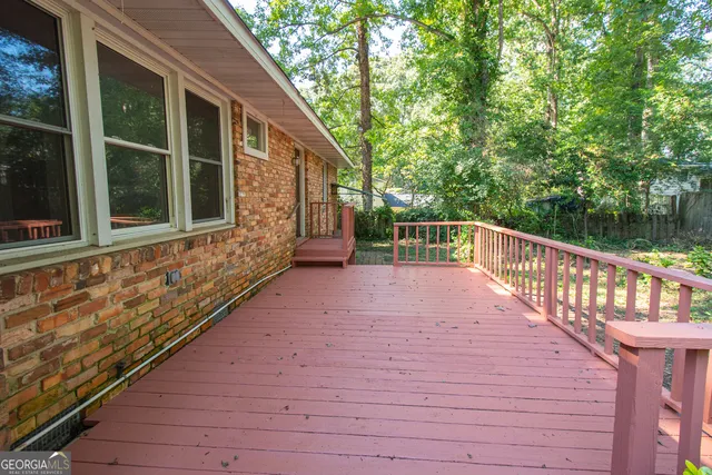 a view of backyard with deck and outdoor seating