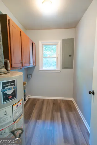 a view of a room with wooden floor and a window