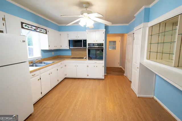 a kitchen with a refrigerator a stove top oven a sink and dishwasher