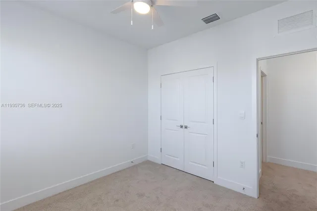 an empty room with a ceiling fan