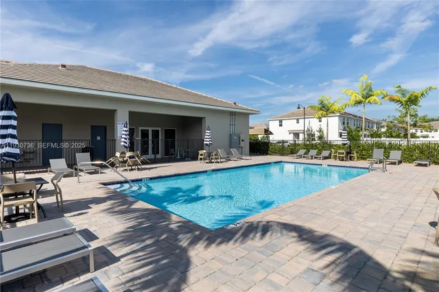 a view of a patio with swimming pool table and chairs
