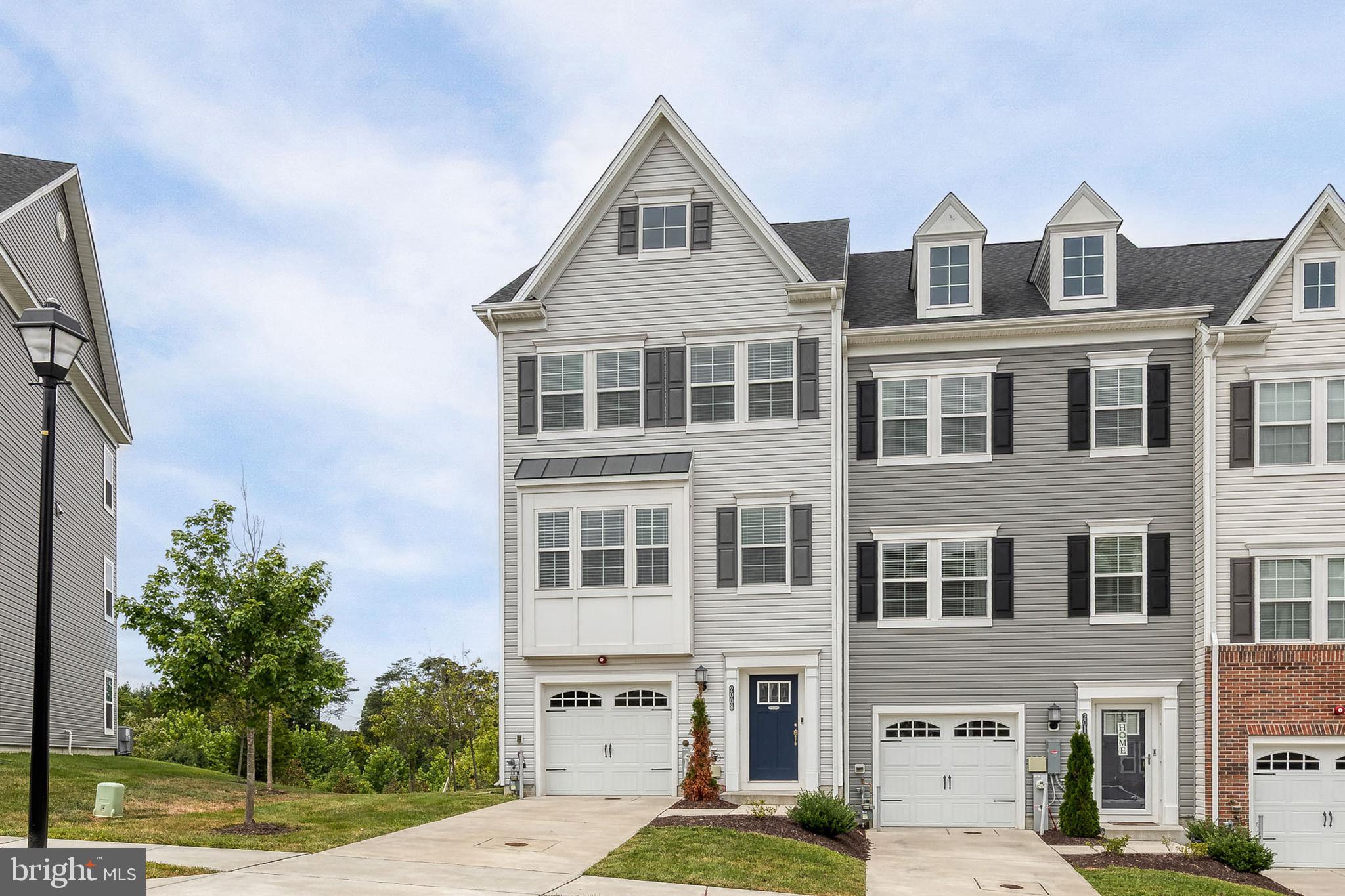a front view of a residential apartment building with a yard