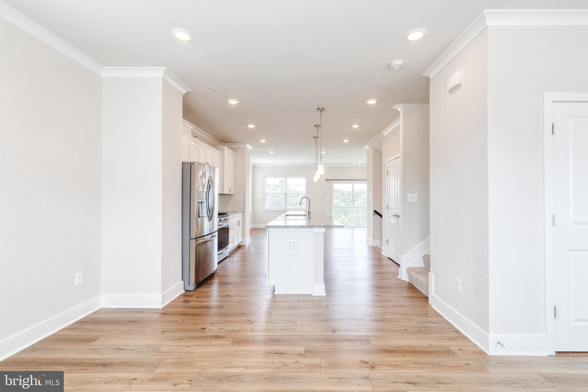 2008 Ivory Brook Road Baltimore, MD 21244 - Photo 20 of 35 a view of a kitchen with a refrigerator and wooden floor