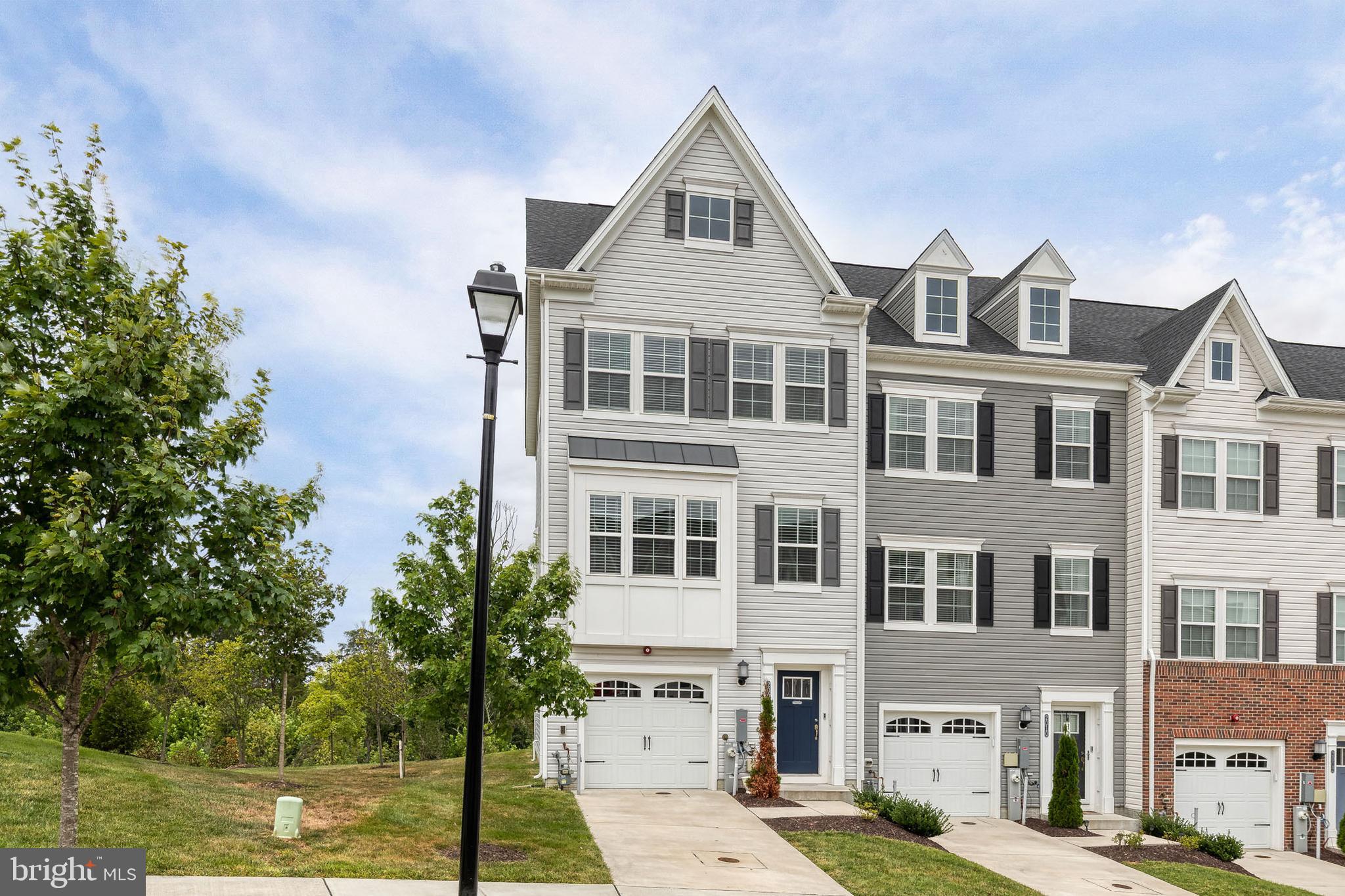 2008 Ivory Brook Road Baltimore, MD 21244 - Photo 2 of 35 a front view of a residential apartment building with a yard