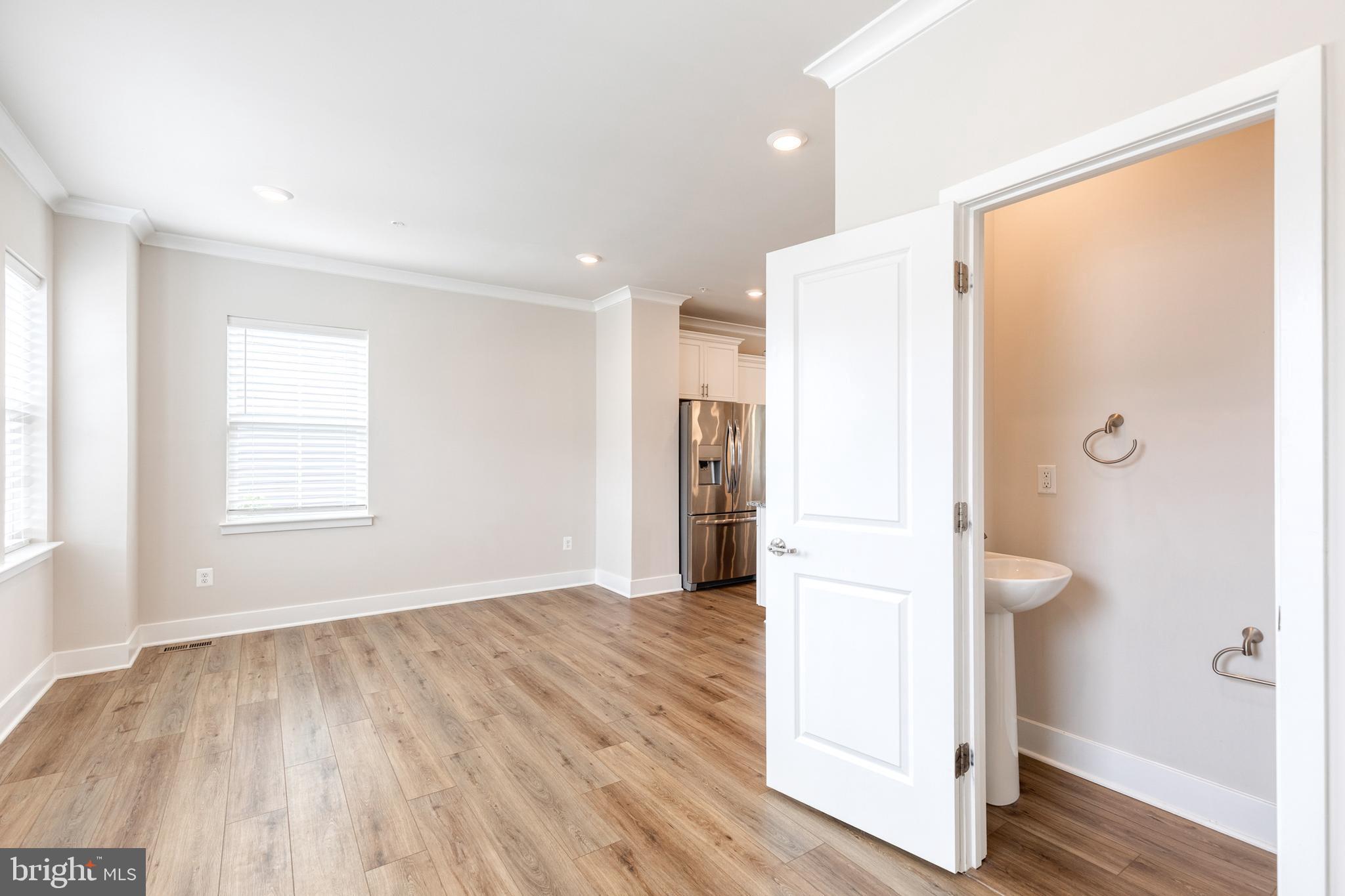 2008 Ivory Brook Road Baltimore, MD 21244 - Photo 21 of 35 a view of a kitchen with wooden floor and a refrigerator