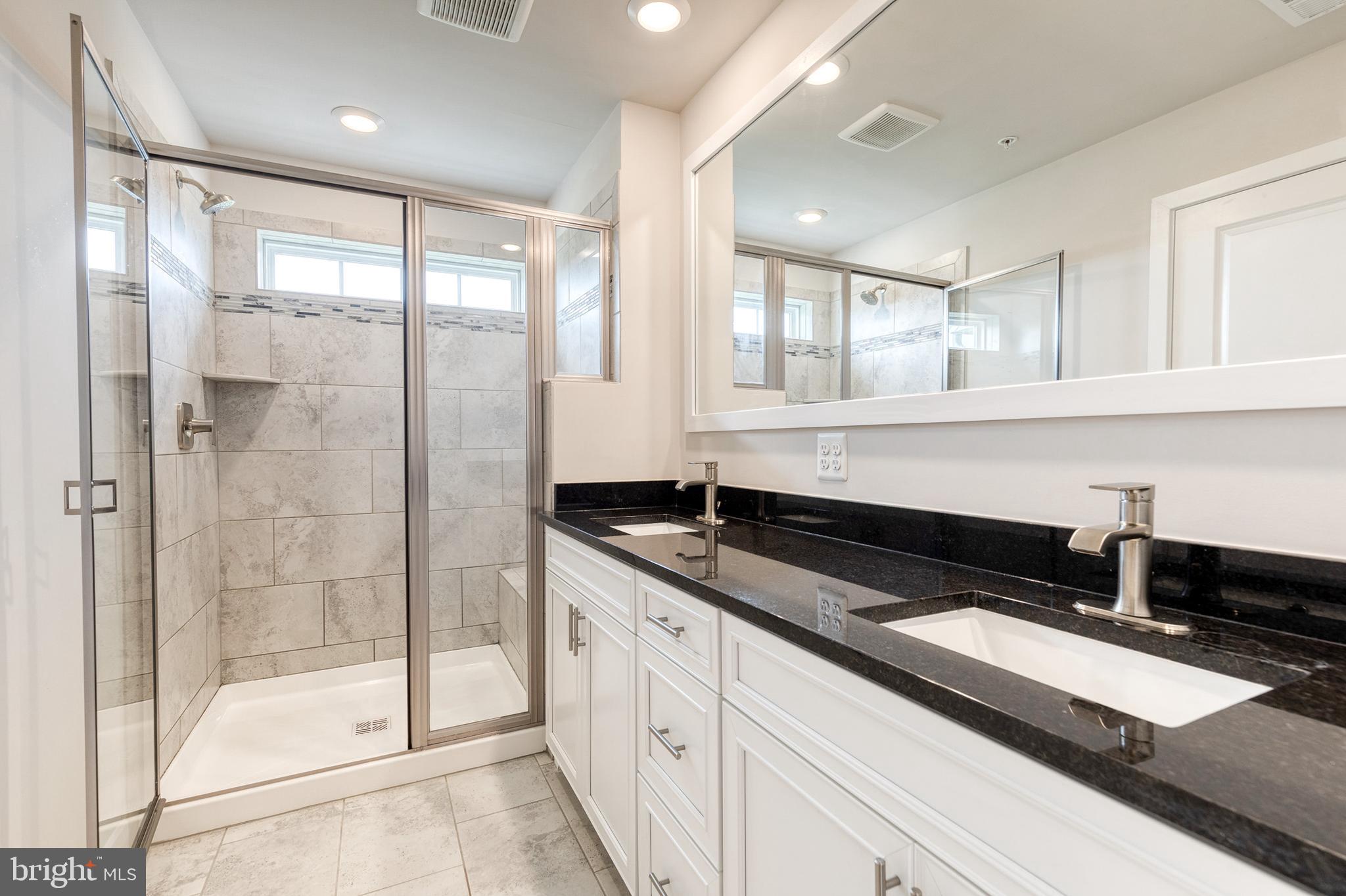 2008 Ivory Brook Road Baltimore, MD 21244 - Photo 25 of 35 a kitchen with granite countertop a refrigerator a sink and white cabinets