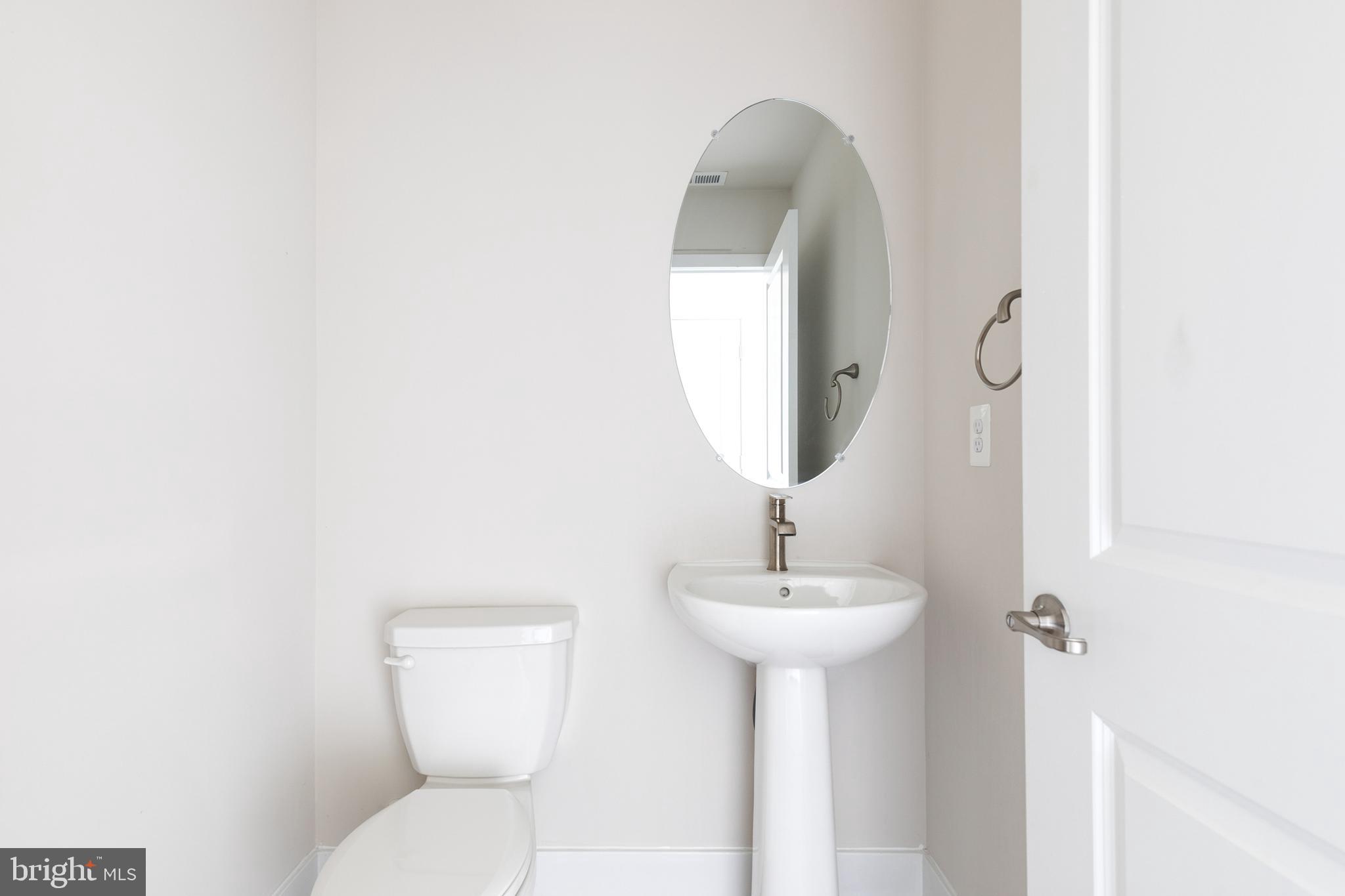 2008 Ivory Brook Road Baltimore, MD 21244 - Photo 7 of 35 a bathroom with a toilet sink and mirror