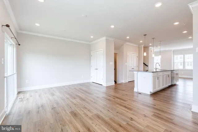 a view of kitchen and hall with wooden floor