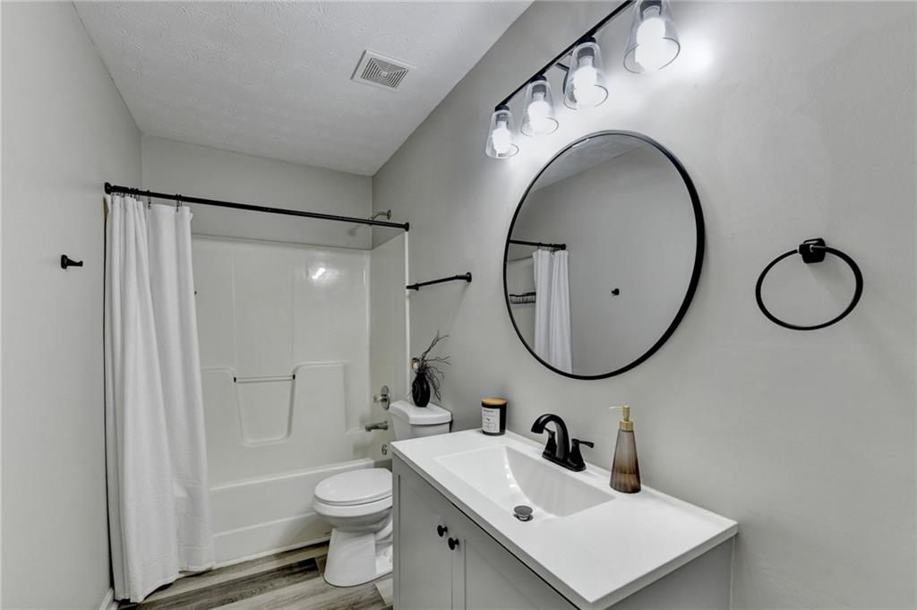 801 Davis Street Monroe, GA 30655 - Photo 31 of 33 a bathroom with a toilet a sink and a mirror