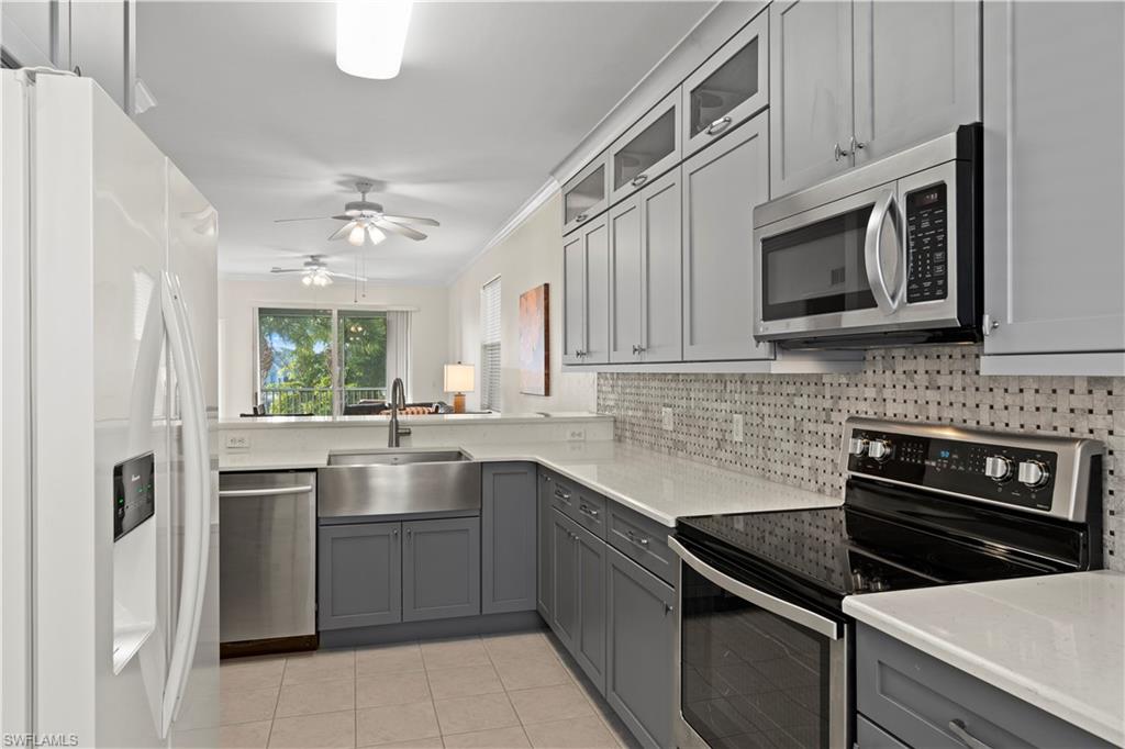 a kitchen with cabinets stainless steel appliances and a counter space
