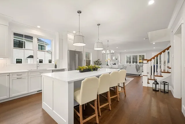 a very nice looking dining room with a large window and stainless steel appliances