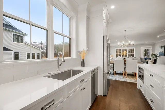 a kitchen with counter top space and windows
