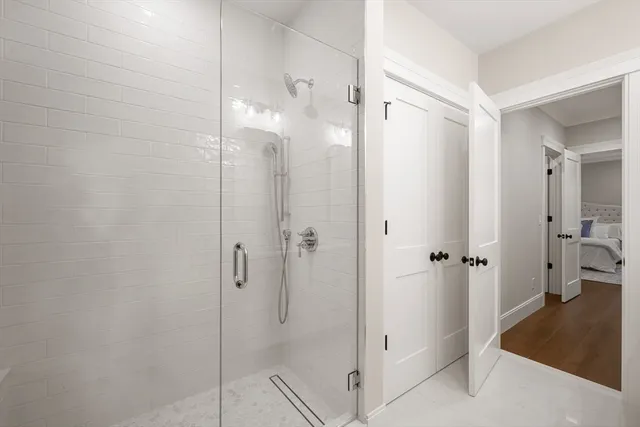 a bathroom with a shower and a glass door