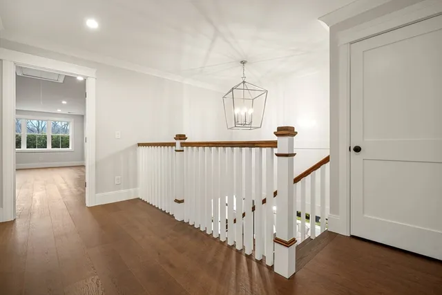 a view of a hallway with wooden floor and entryway