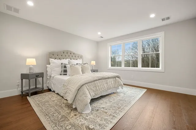 a bedroom with a large bed and a window