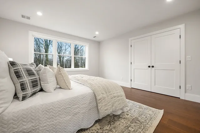 a bedroom with a large bed and a window