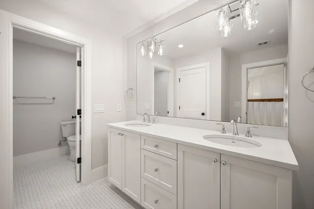 a bathroom with a sink double vanity and shower