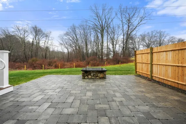 a view of backyard with wooden fence