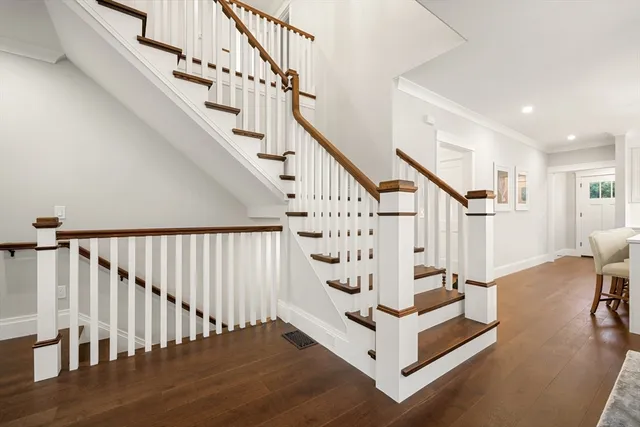 a view of entryway with wooden floor and stairs