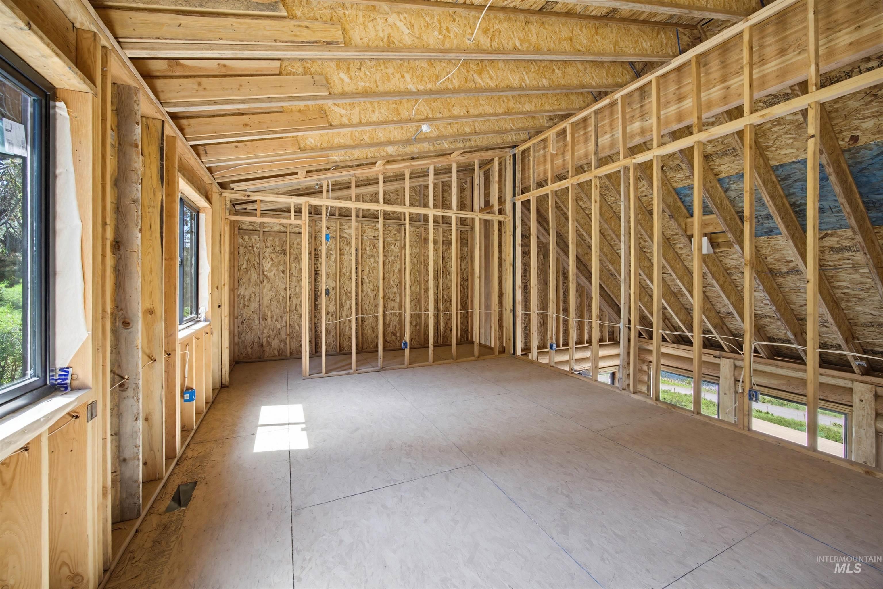 3322 Big Creek Road New Meadows, ID 83654 - Photo 38 of 50 New construction framing featuring multiple window openings, plywood subflooring, and an exposed vaulted ceiling