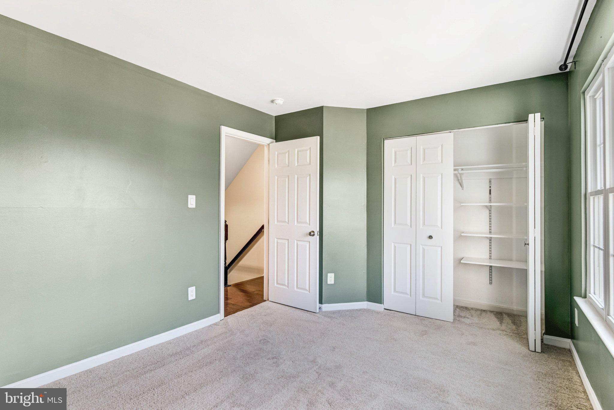 22142 Trailside Square Sterling, VA 20164 - Photo 17 of 32 an empty room with closet and windows