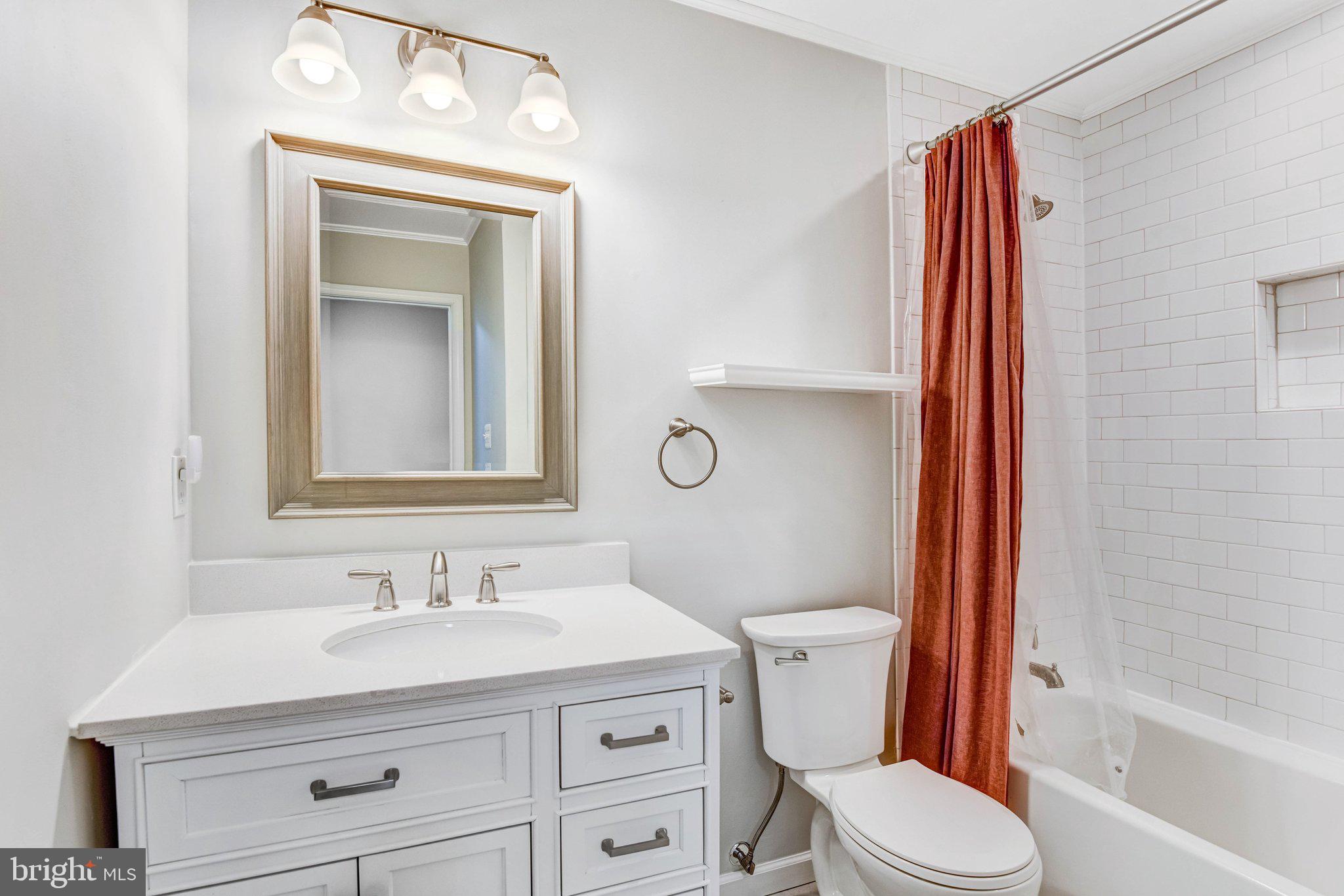 22142 Trailside Square Sterling, VA 20164 - Photo 18 of 32 a bathroom with a granite countertop toilet sink and mirror