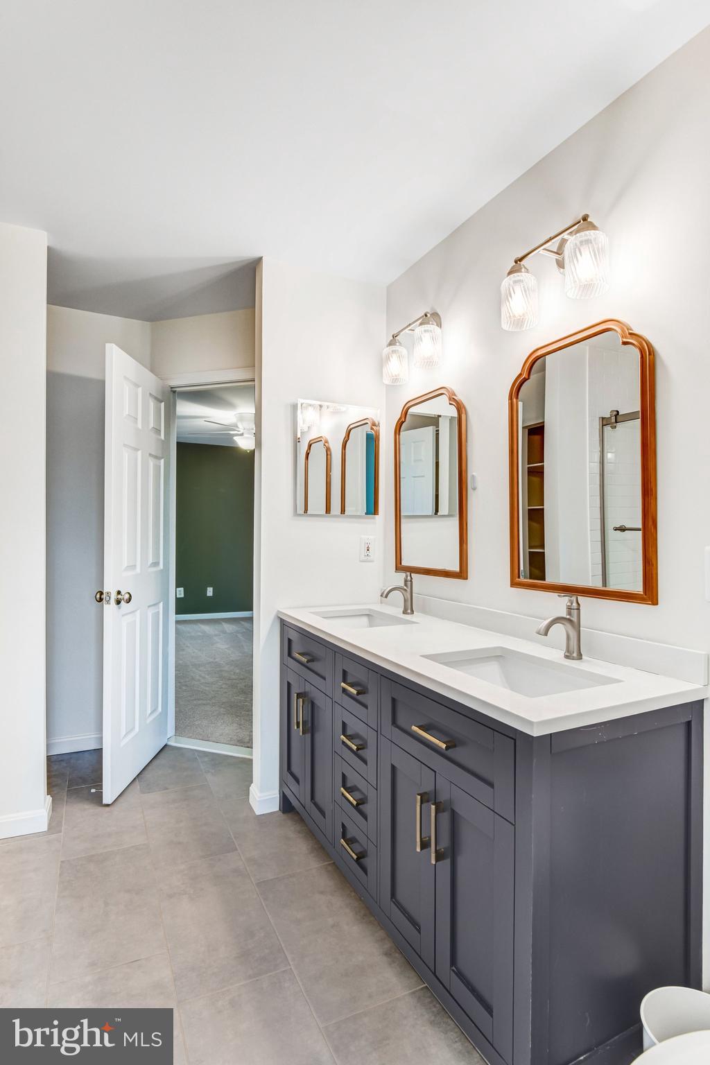 22142 Trailside Square Sterling, VA 20164 - Photo 24 of 32 a spacious bathroom with double vanity sinks and a bathtub