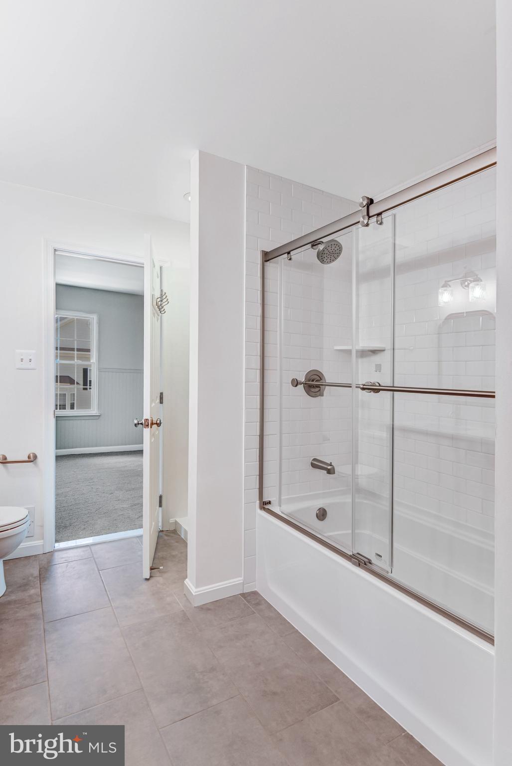 22142 Trailside Square Sterling, VA 20164 - Photo 25 of 32 a bathroom with a glass shower door