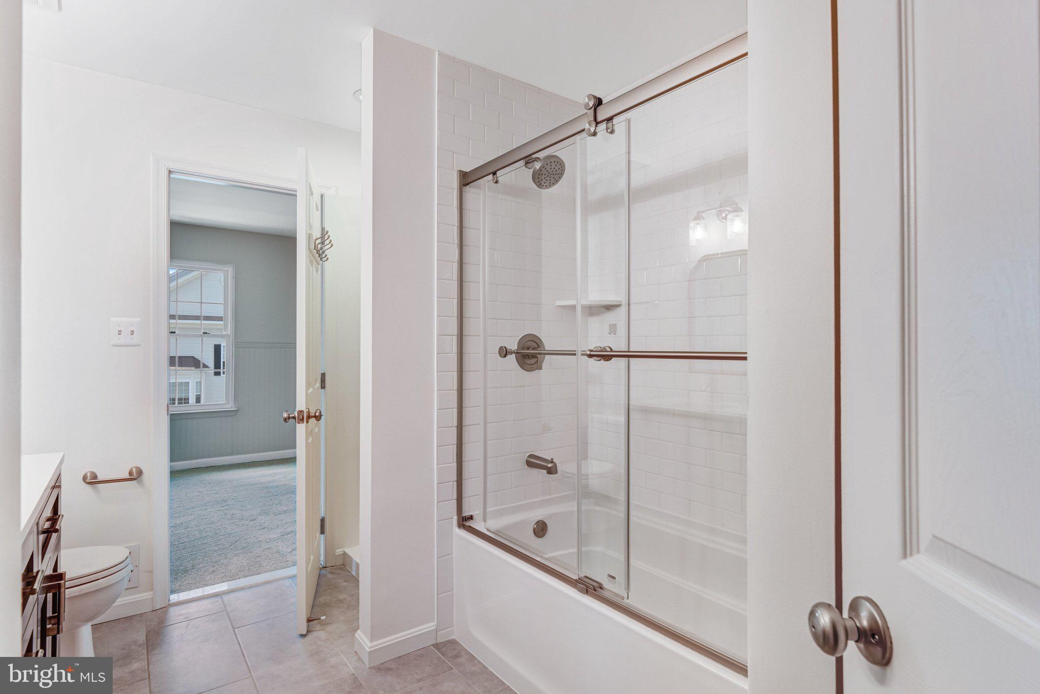22142 Trailside Square Sterling, VA 20164 - Photo 26 of 32 a bathroom with a glass shower door
