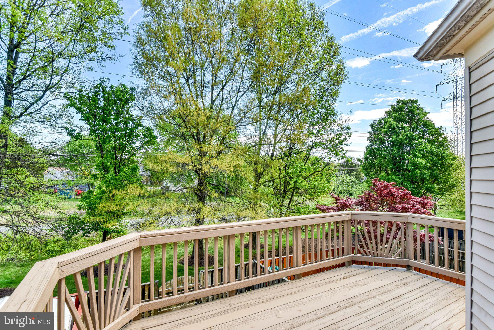 22142 Trailside Square Sterling, VA 20164 - Photo 30 of 32 a view of balcony with wooden floor and fence