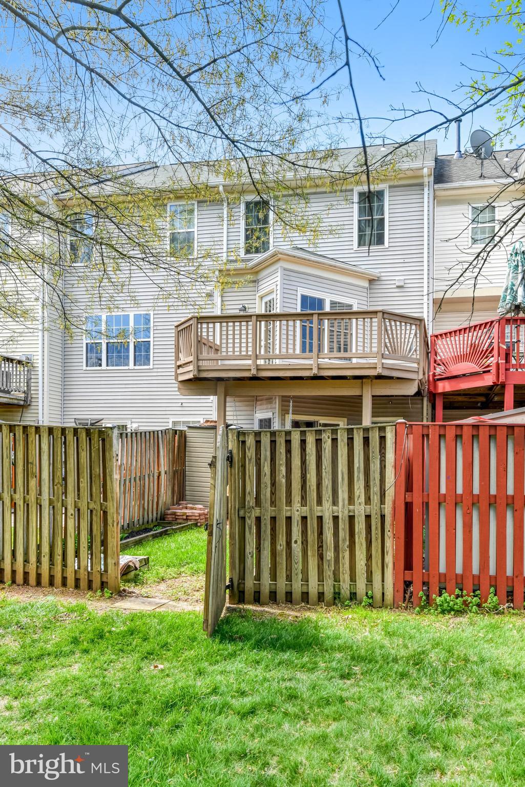 22142 Trailside Square Sterling, VA 20164 - Photo 32 of 32 a view of a house with a yard and a deck