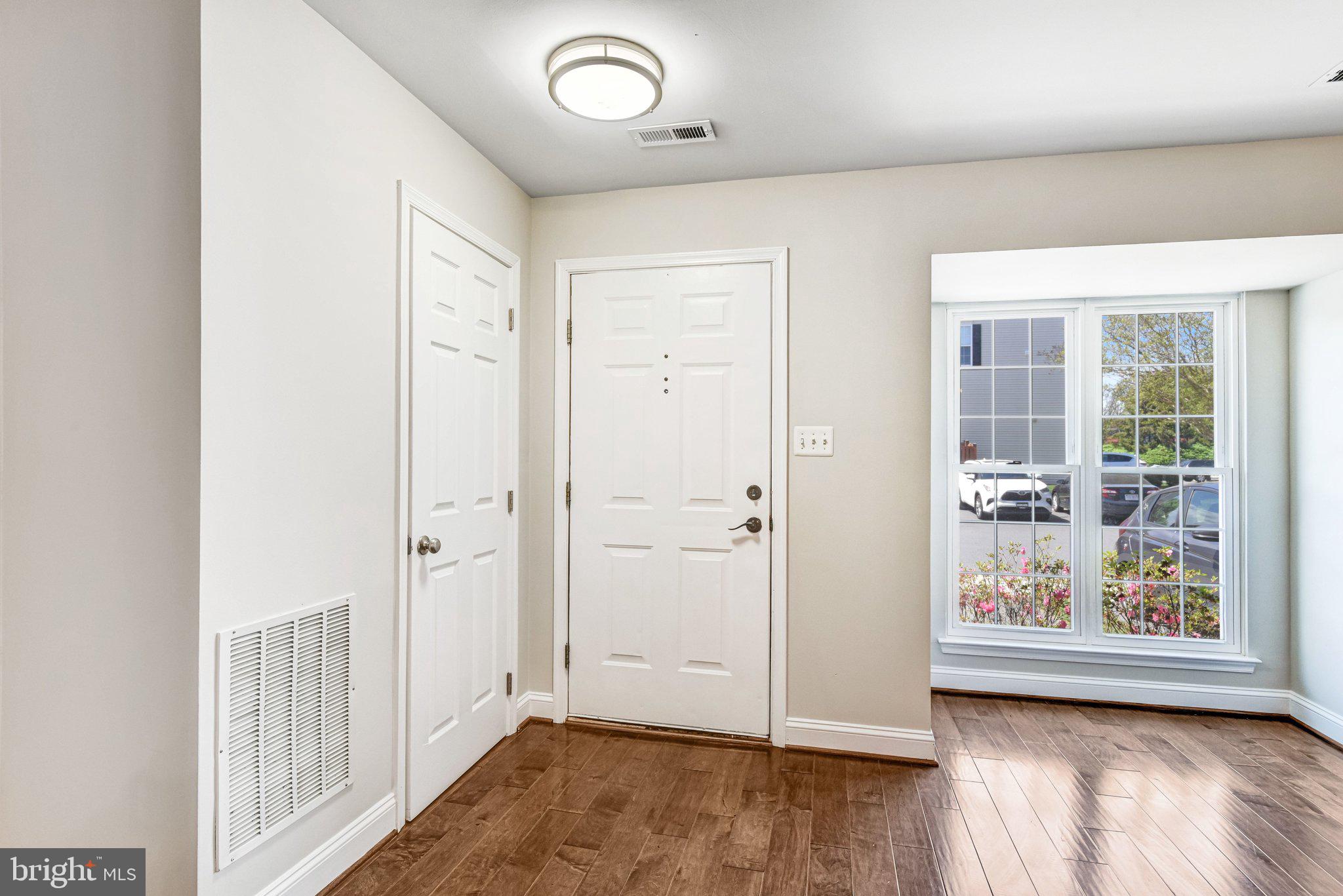 22142 Trailside Square Sterling, VA 20164 - Photo 4 of 32 an empty room with wooden floor and window