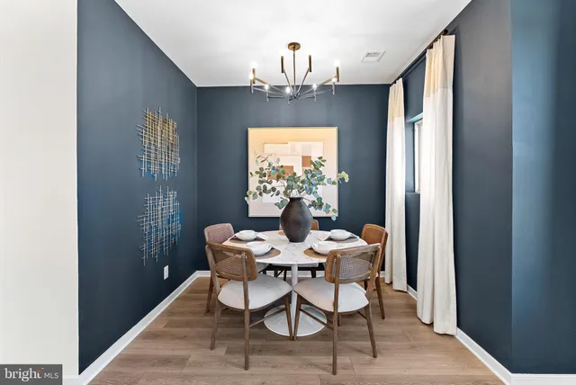 a view of a dining room with furniture and chandelier