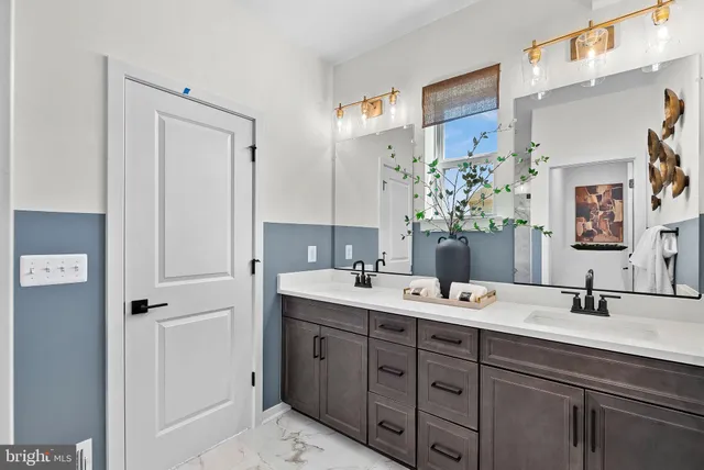 a bathroom with a double vanity sink mirror and double