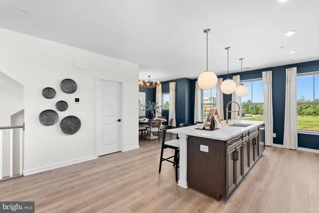 a kitchen with stainless steel appliances granite countertop a stove and a wooden floors